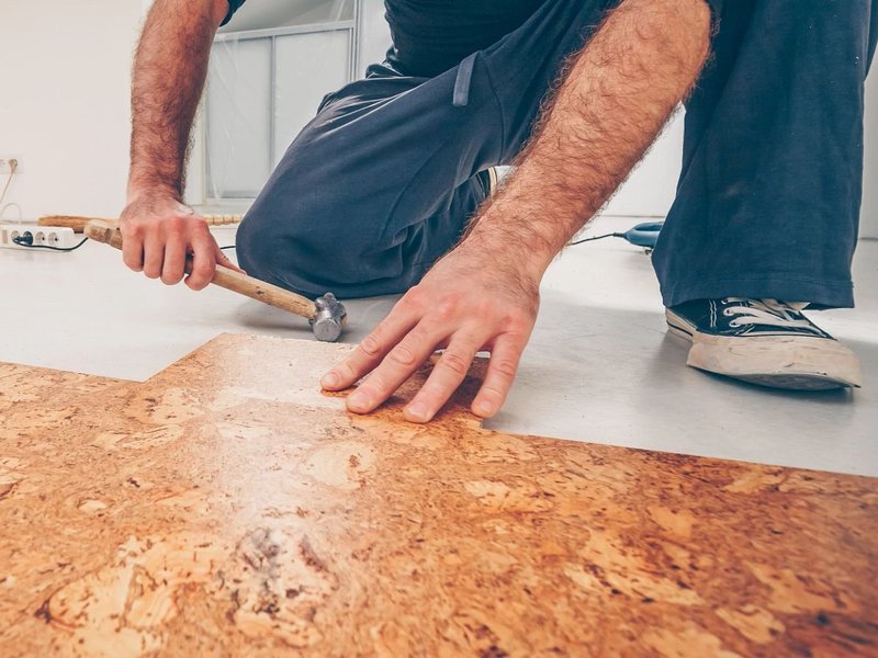 person installing cork flooring from Flooring Source in the Auburn, MA area