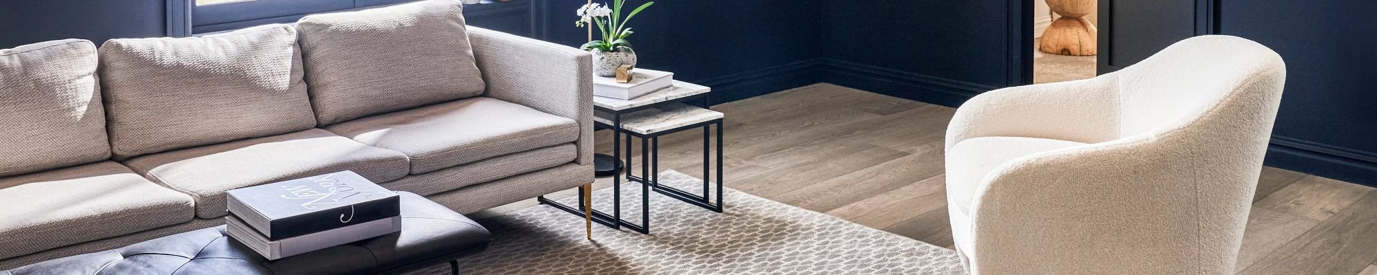 living room with hardwood flooring and a large beige area rug from Flooring Source in the Auburn, MA area