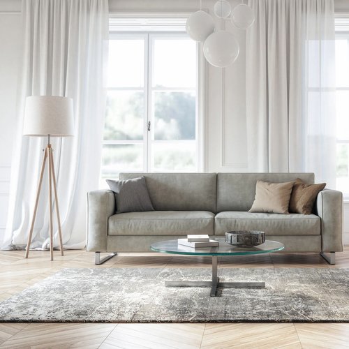 Bright living room with light wood-look flooring and a gray area rug from Flooring Source in the Auburn, MA area