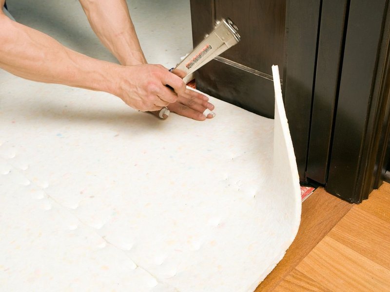 person installing underlayment from Flooring Source in the Auburn, MA area