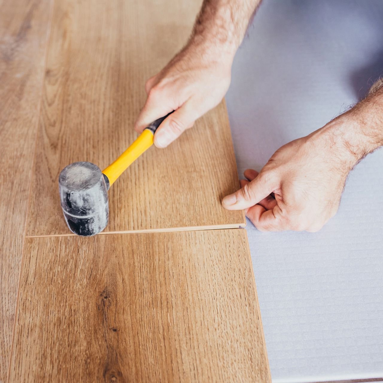 Person installing flooring from Flooring Source in the Auburn, MA area