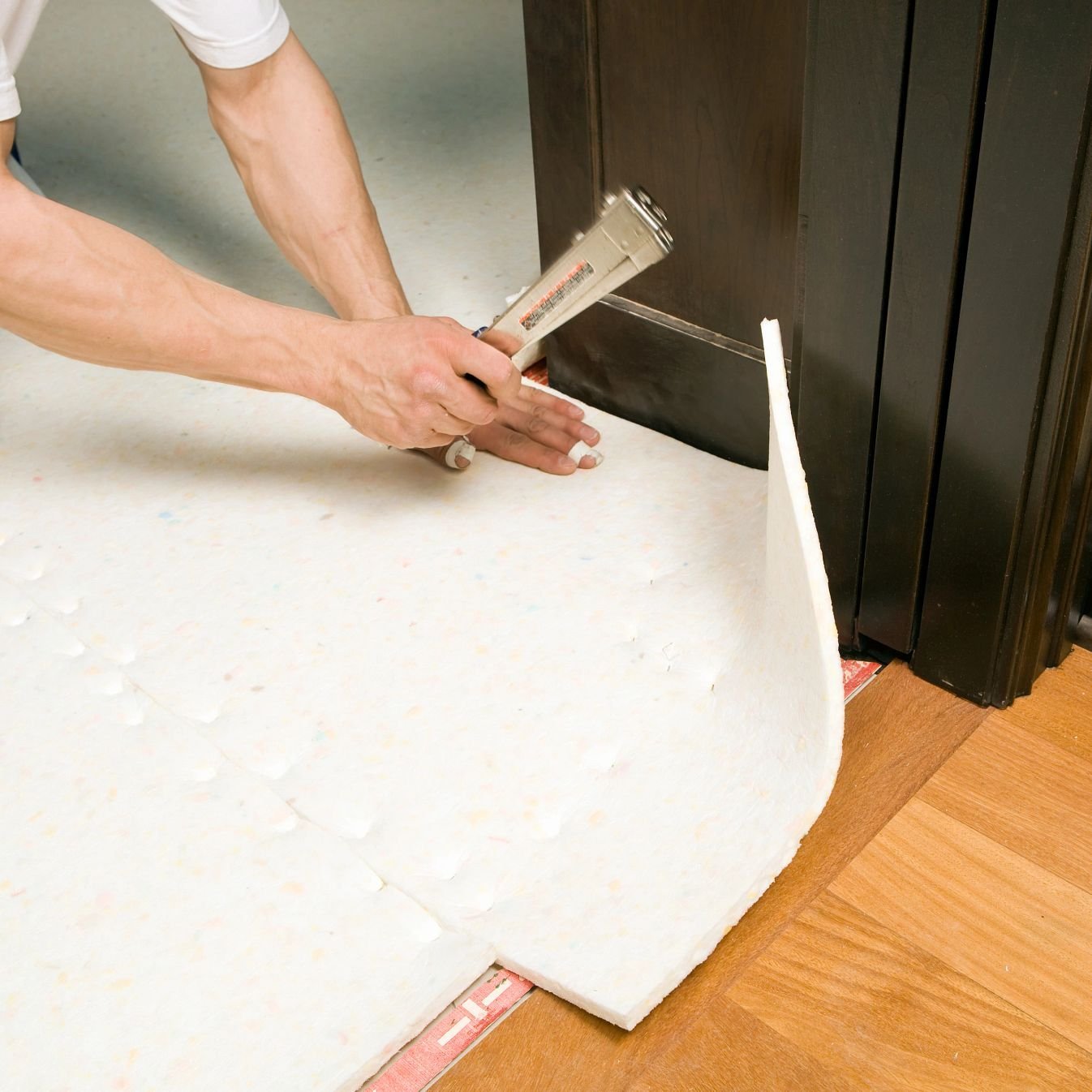 person installing underlayment from Flooring Source in the Auburn, MA area